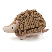 Load image into Gallery viewer, A plush hedgehog toy with a textured brown spiky back, beige face and legs, pink inner ears, and a small white accent on its tail, photographed on a clean white background.
