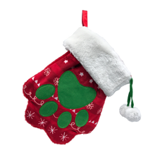 Load image into Gallery viewer, A plush Christmas stocking shaped like a mitten, featuring a red body with white snowflake patterns, a green paw print design, a white faux-fur cuff, and a red hanging loop, shown on a plain white background.
