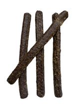 Load image into Gallery viewer, Dark brown dog treats on a white surface 
