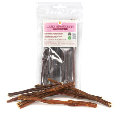 Packaged JR Lamb Spaghetti dog treats displayed with several individual treats outside the packaging to showcase the product.