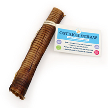 Load image into Gallery viewer, A rolled brown ostrich-straw chew toy with a white rubber band, shown next to its white product packaging card on a plain white background.
