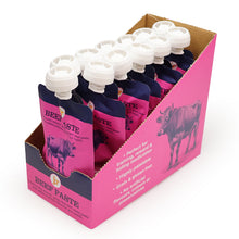 Load image into Gallery viewer, A retail display box filled with pink and navy beef paste pouches with white caps, photographed on a clean white background.
