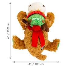 Load image into Gallery viewer, A plush dog toy shaped like a brown reindeer wearing a green knit hat with 'KONG' written on it, a red scarf, and a white face, shown with dimension arrows and labels indicating 6 inches tall by 4 inches wide on a white background.
