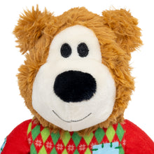 Load image into Gallery viewer, A plush teddy bear with golden brown faux fur, a cream-colored face, black embroidered eyes and nose, and a red sweater with a green and red argyle pattern.
