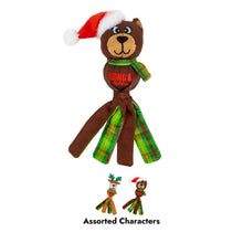 Load image into Gallery viewer, A brown plush bear-shaped dog toy with a red Santa hat, green plaid scarf, and green plaid legs, shown on a white background. Small thumbnails at the bottom show alternate character designs with the text 'Assorted Characters'.
