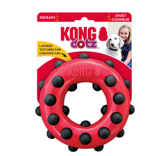Load image into Gallery viewer, Kong Dotz squeaker dog toy in red with black textured dots, shown in its original retail packaging on a white background.
