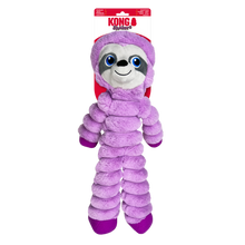 Load image into Gallery viewer, Kong Sloth plush dog toy in a purple hooded outfit, hanging from its original retail packaging header card against a plain white background.
