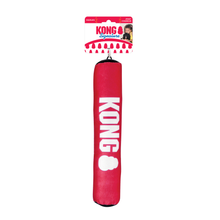 Load image into Gallery viewer, A red KONG brand dog toy or training pad hanging from its retail header card, shown against a plain white background.
