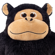 Load image into Gallery viewer, A close-up of a plush monkey toy with black shaggy faux fur, a tan face and ears, and large embroidered eyes on a plain white background.
