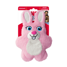 Load image into Gallery viewer, A pink plush bunny squeaker dog toy with a white belly and blue eyes, attached to a red cardboard backing card labeled 'SQUEAKS' and 'JOUST COUINEUR'.

