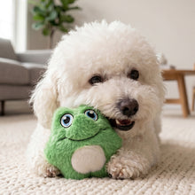 Load image into Gallery viewer, White dog playing with a green plush toy on a carpeted floor.
