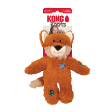 Load image into Gallery viewer, Kong Puppy Kicks plush toy dog in its retail packaging, featuring an orange-brown plush puppy with a cream muzzle and a blue stitched patch on its chest.
