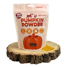 Load image into Gallery viewer, Bag of Nova Dog Chews pumpkin powder on a wooden block with pumpkin powder spilling out.
