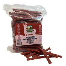 Load image into Gallery viewer, A clear plastic bag of Produce Farm Venison Muscle Meat Sticks dog treats with a red and white label, shown on a white background with several sticks spilled in front.
