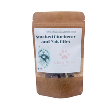 Load image into Gallery viewer, Package of 'Smoked Blueberry and Yak Bites' dog treats with visible treats on a white background
