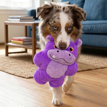 Load image into Gallery viewer, Dog holding a purple hippo toy in a living room
