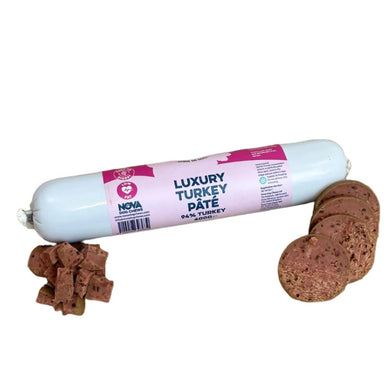 A rolled-up tube of Nova Luxury Turkey Pâté alongside several cut pieces of the pâté, designed to be used as dog treats.