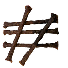 Load image into Gallery viewer, Dog treats shaped like bones on a light gray background
