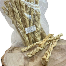 Load image into Gallery viewer, Braided dog treat in a clear package on a wooden surface
