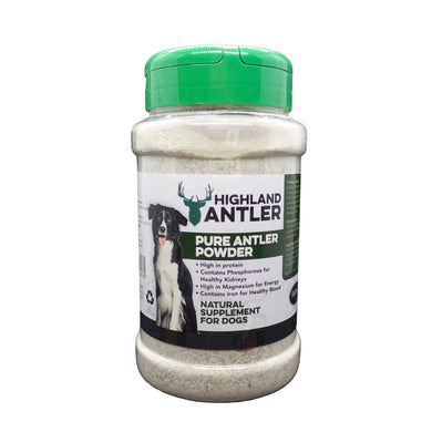 A plastic bottle of Highland Antler Pure Antler Powder with a green cap. The label shows a dog and text indicating the product is a natural supplement for dogs.