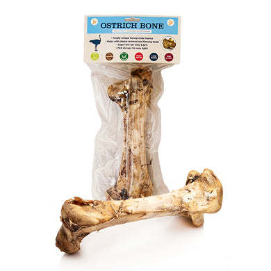 A natural ostrich bone chew treat for dogs, packaged in a clear plastic bag with a label showing product information and branding.