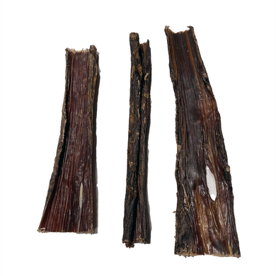 Three flat beef stick treats for dogs placed on a white background.
